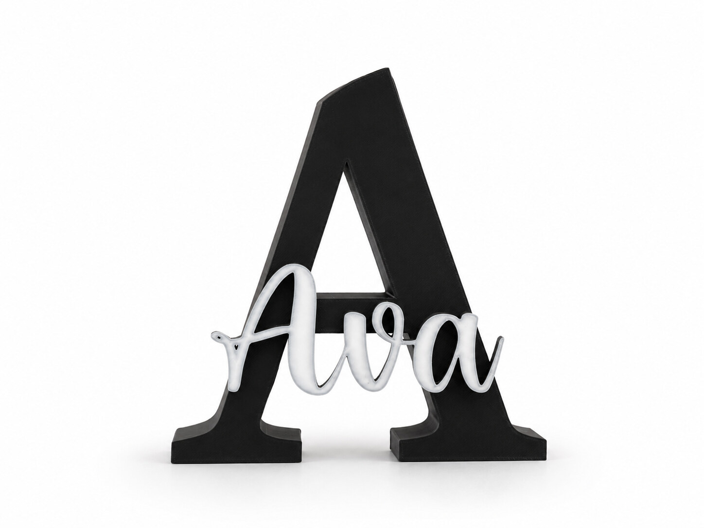 Custom 3D printed name sign — a white script “Ava” set across a large black serif A, standing on a white backdrop